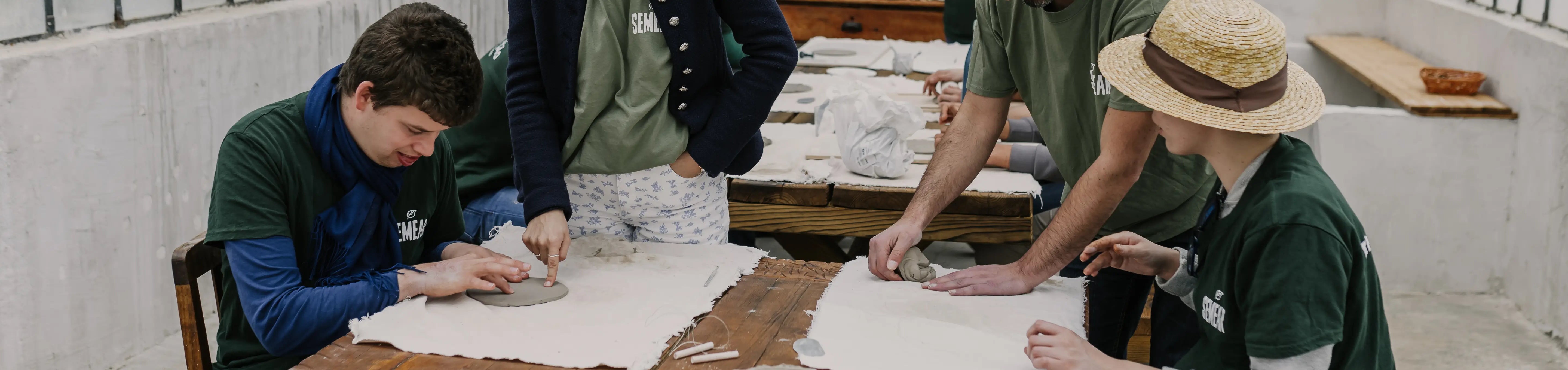 People working with clay in a workshop setting