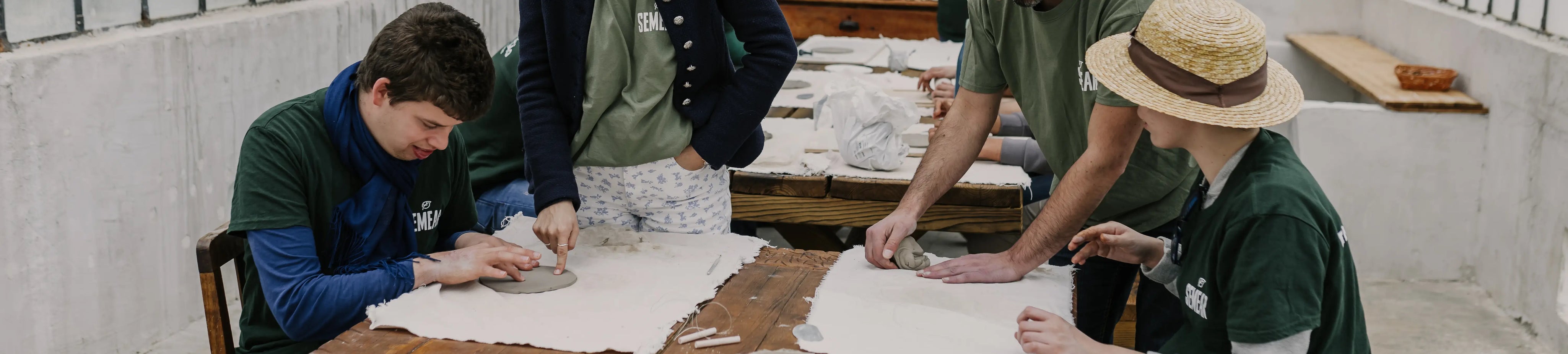 People working with clay in a workshop setting